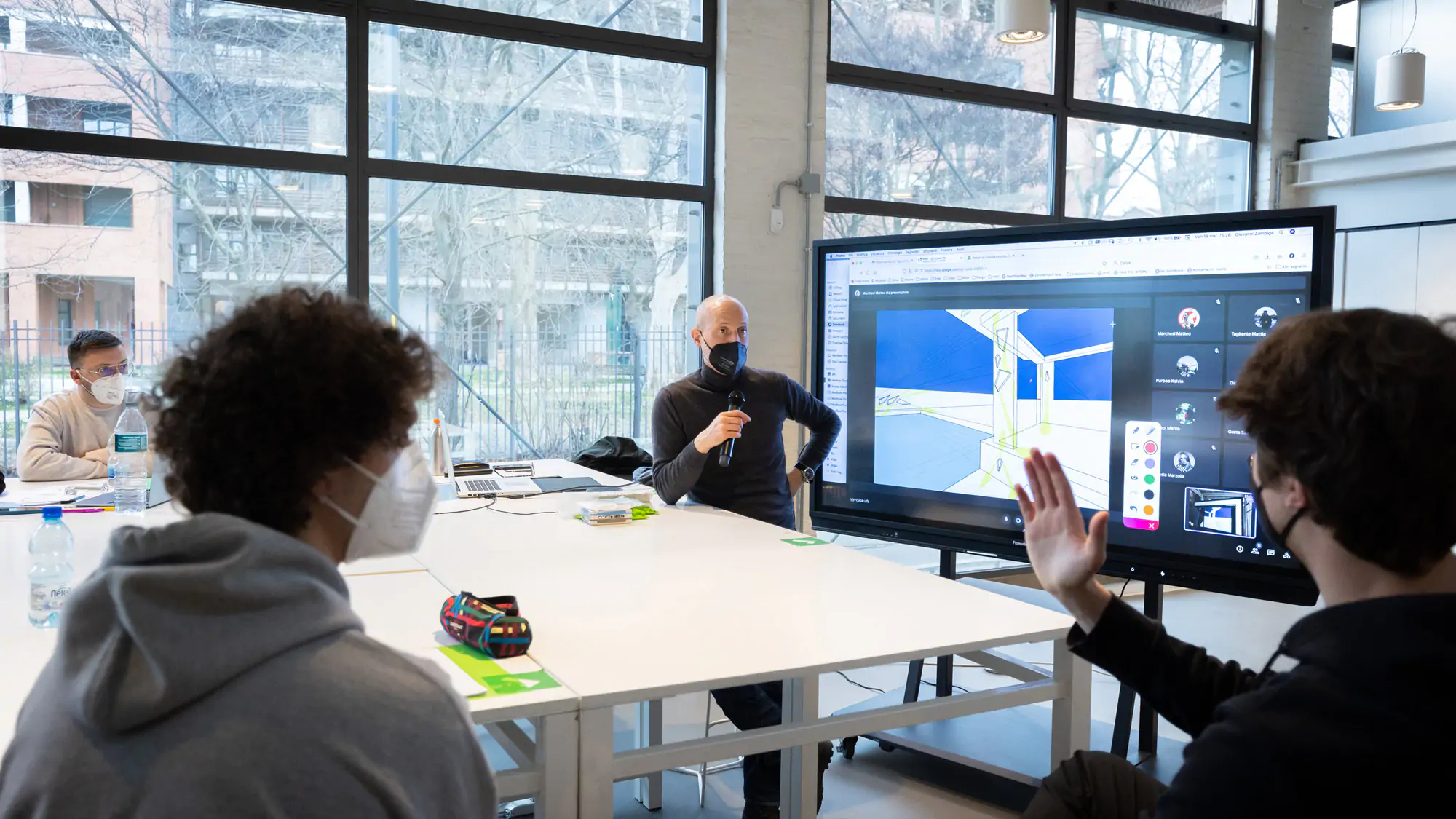 Students at IAAD university focused on a classroom presentation during an Interior design lesson