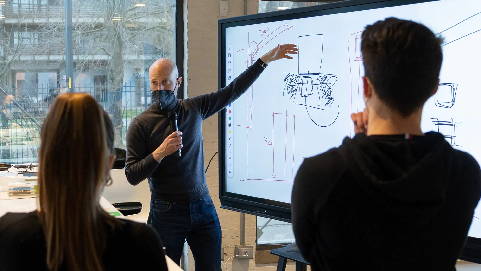 An Interior design Professor presenting to a group of students at IAAD University